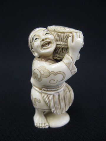 Carved Ivory Netsuke of a Man carrying