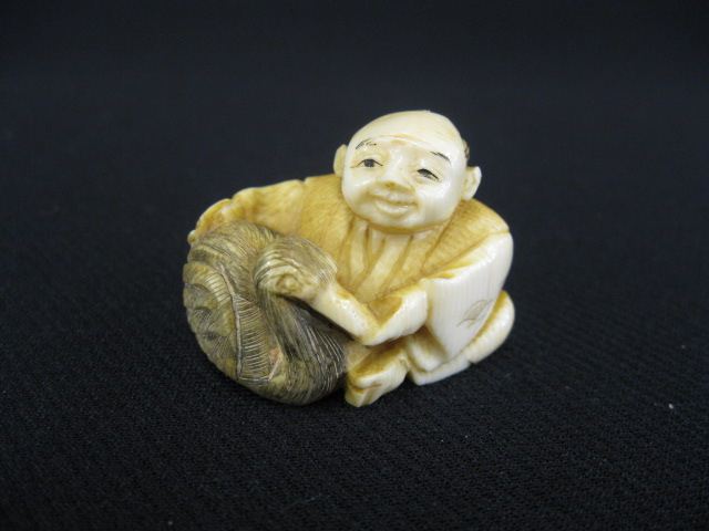 Carved Ivory Netsuke of a Seated