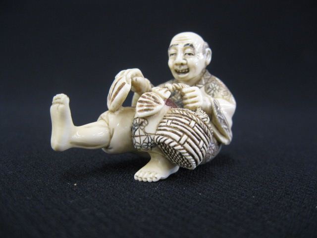 Carved Ivory Netsuke of a Seated