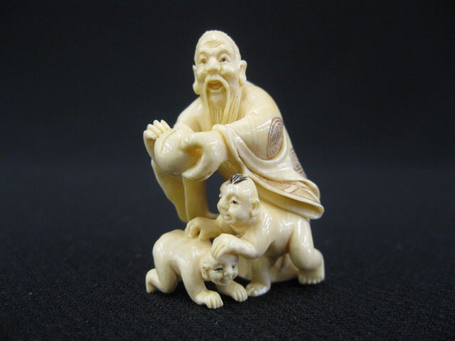 Carved Ivory Netsuke of a Man holding