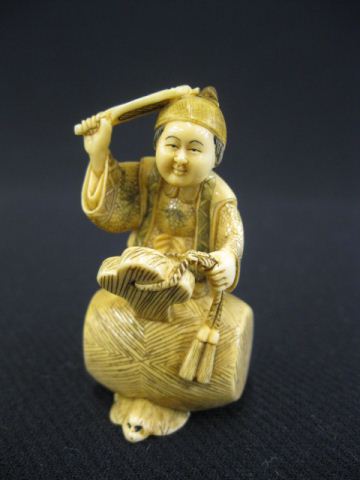 Carved Ivory Netsuke of a Man holding