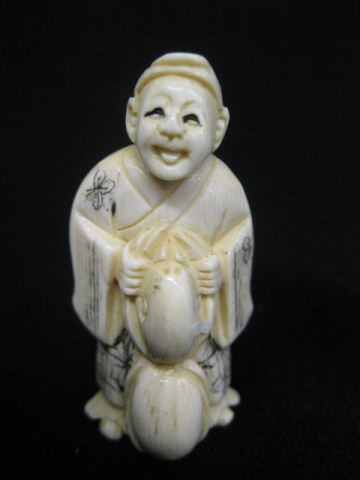 Carved Ivory Netsuke of a Man holding