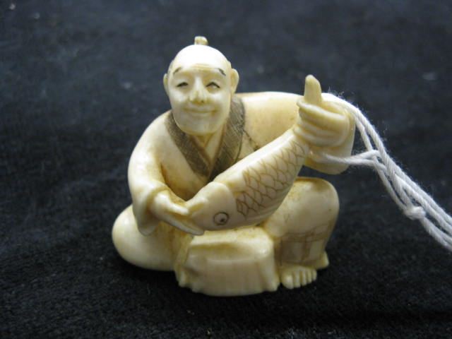 Carved Ivory Netsuke of Man with Fish