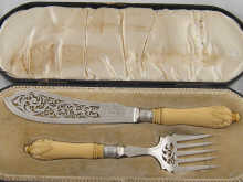A pair of silver fish servers with