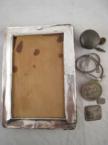 A silver picture frame (AF) together