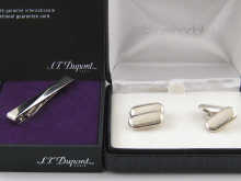 A pair of silver cufflinks and a boxed