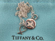 A silver pendant and chain by Tiffany