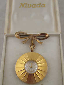 A gold plated ladys lapel watch by