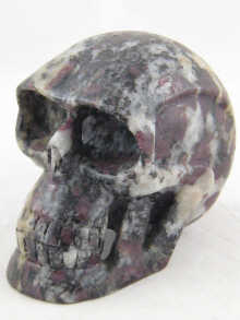 A carved stone (probably granite) skull