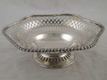 A pierced silver cake dish with
