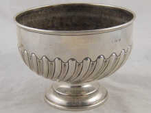 A silver rosebowl with swirl half ribbed
