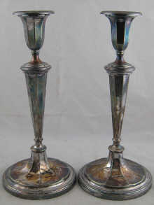 A pair of silver plated candlesticks 14f8e0
