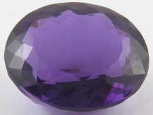 A loose polished amethyst approx.