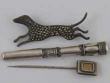 A silver and marcasite hound brooch