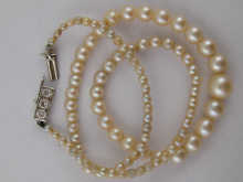 A cultured pearl necklace with diamond