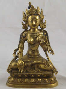 A gilded bronze Tibetan deity with black