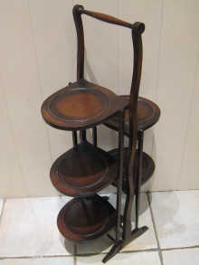 A mahogany folding cake stand with