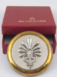 A boxed brass paperweight with 150012