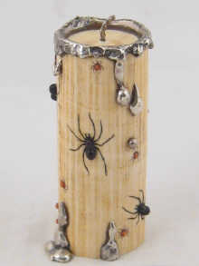 An ivory candle decorated with applied
