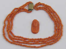A coral cameo and necklace.