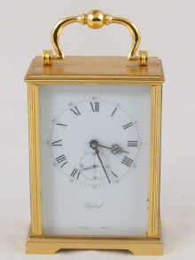 A brass eight day carriage clock