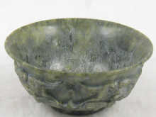 A green hardstone bowl carved in relief