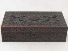 A large heavily carved wooden cigar 15008e