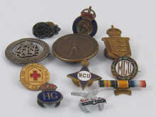 A quantity of badges including Red Cross