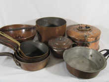 Eleven copper cooking vessels being