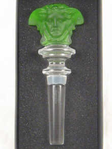 A green glass Janus mask bottle