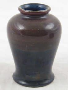 Moorcroft. A small vase dark brown shading