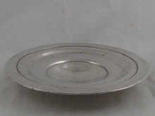 A circular silver fruit dish on