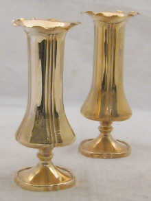 A pair of silver spill vases with fluted