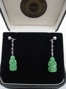 A pair of carved jade earrings