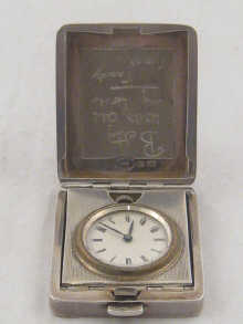 A small silver travelling clock 1501ac