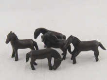 Five stylised bronze horses in