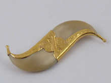 A tiger's claw brooch with engraved