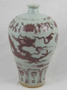 A Chinese pale celadon vase with red/brown