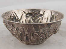A Japanese silver bowl heavily embossed