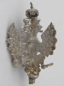 A three faced silver staff finial