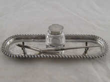 A silver inkstand with heavily