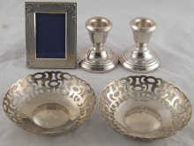 A pair of silver dwarf candlesticks