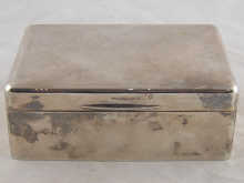 A silver cigarette box with domed lid