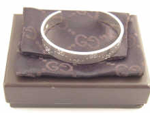 A Gucci silver bangle in original