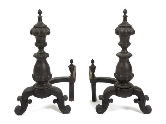 A Pair of Cast Iron Andirons each having