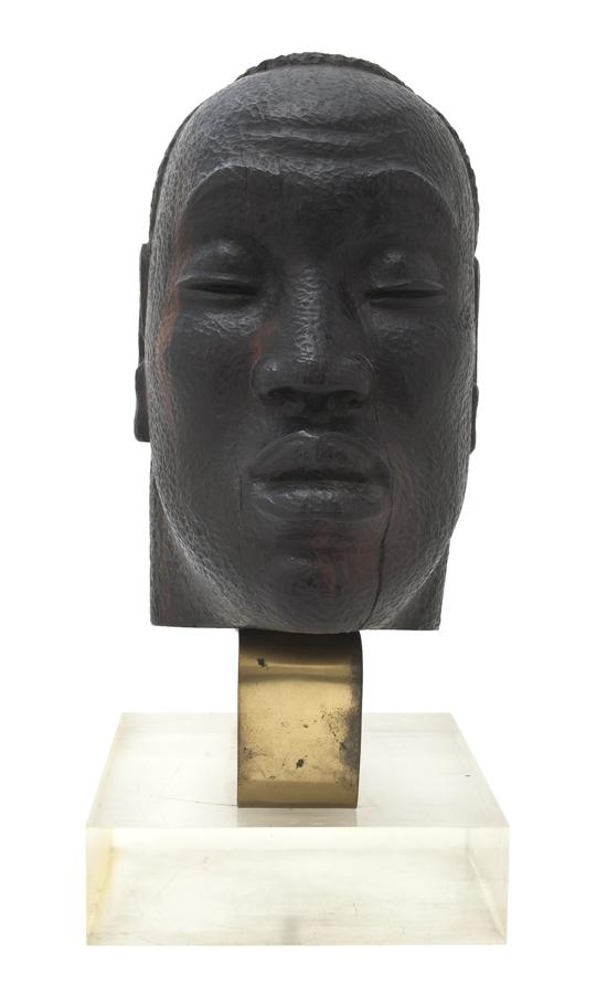 *A Carved Hardwood Bust depicting