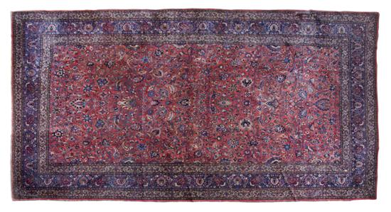 A Sarouk Wool Rug having a red