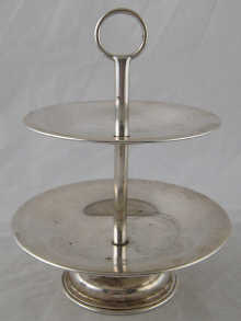 A two tier silver sweets dish marked