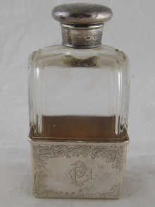 A cut glass brandy flask with silver