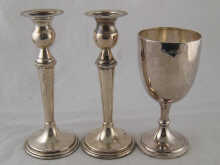 A pair of Egyptian silver candlesticks